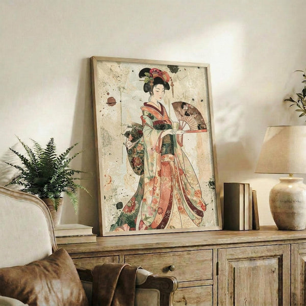 May include: Framed vintage Japanese artwork featuring a geisha in colorful floral kimono holding a decorative fan, displayed on weathered wood sideboard with aged patina background, surrounded by fern plant, ceramic vase, and books in neutral-toned living room setting