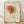 May include: Framed art print featuring abstract line drawing of a rose with orange and yellow watercolor washes on cream background, displayed on light wooden floor against white wall with natural shadows. The minimalist botanical artwork shows flowing black lines forming flower petals and stem with "PICASSO" and "Centre Pompidou" text, housed in natural wood frame.