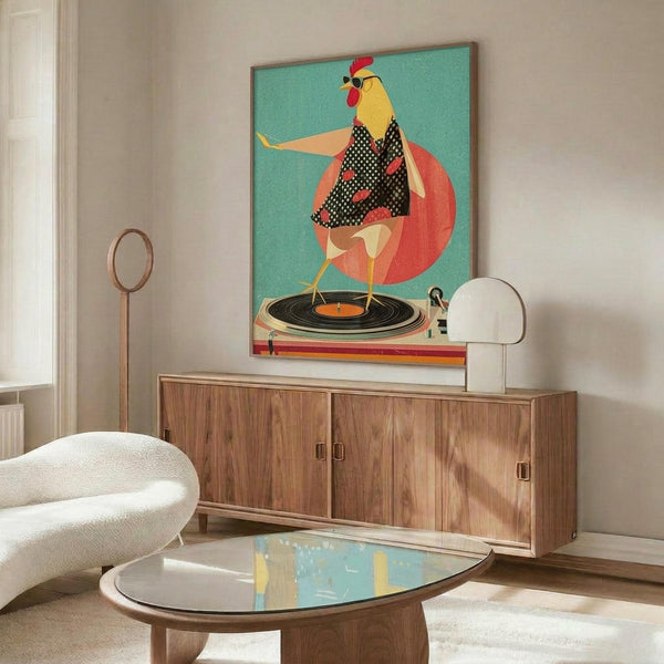 May include: Colorful poster showing a stylized chicken wearing sunglasses and polka dot clothing, dancing on a vinyl record turntable against a teal background with coral circle. Displayed above a mid-century walnut credenza in modern living room with white curved chair, brass floor lamp, oval glass coffee table, and white table lamp.