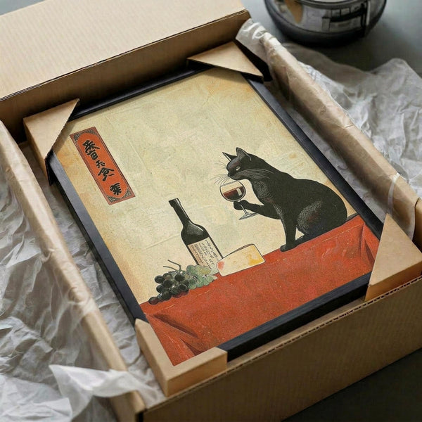 May include: Framed vintage-style Japanese ukiyo-e print featuring a black cat holding a wine glass, sitting beside a wine bottle and grapes on an orange surface. The aged beige artwork has Japanese text in a red banner. Print is displayed in a black frame, packaged in cardboard shipping box with tissue paper and protective corners.