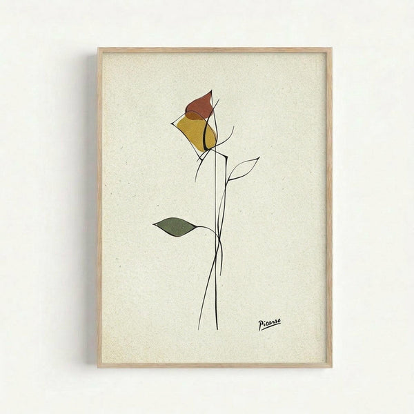 May include: Framed minimalist line drawing of a single rose with geometric colored shapes in yellow, rust red, and green on cream textured paper background. Simple black line art stem with leaves, signed "Picasso" in bottom right corner. Light wood frame mounted on white wall.