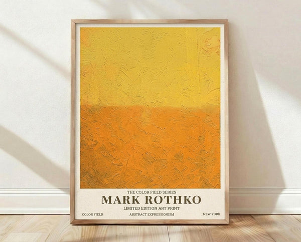 May include: Framed abstract art print with yellow and orange color field gradient, thick textured brushstrokes visible, mounted in light wood frame against white wall on wooden floor with soft natural lighting and shadows
