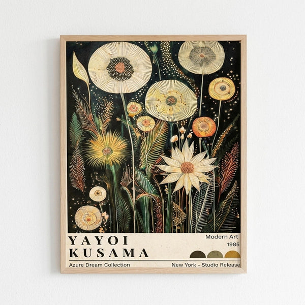 A framed botanical art print featuring stylized flowers and plants on a black background. The artwork shows cream and yellow dandelion-like blooms with radiating petals, feathery grasses, and dotted seed heads scattered throughout. Green stems and foliage weave between the flowers, with small white dots creating a starry effect across the dark backdrop. The print has exhibition-style text at the bottom reading "YAYOI KUSAMA" with "Modern Art 1985" and other details. The natural wood fram