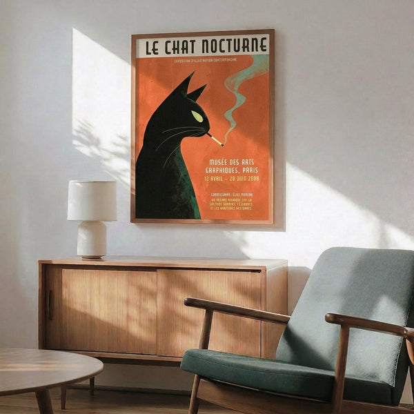 May include: Vintage-style poster featuring black cat silhouette with yellow eye smoking against orange background, displayed in wooden frame above mid-century modern credenza. Scene shows teal upholstered armchair with wooden arms, white ceramic table lamp, and round coffee table in bright, naturally-lit room with white walls.