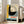 May include: Framed vintage Bauhaus poster leaning against white wall next to beige sofa in bright room with windows. Artwork features bold geometric design with large black semicircle, concentric circles in cream and orange tones, yellow and gray color blocks. German text reads "OFFSET BUCH UND WERBEKUNST HEFT 7 1926" in red and black typography. Natural wood frame, textured paper appearance with distressed edges.
