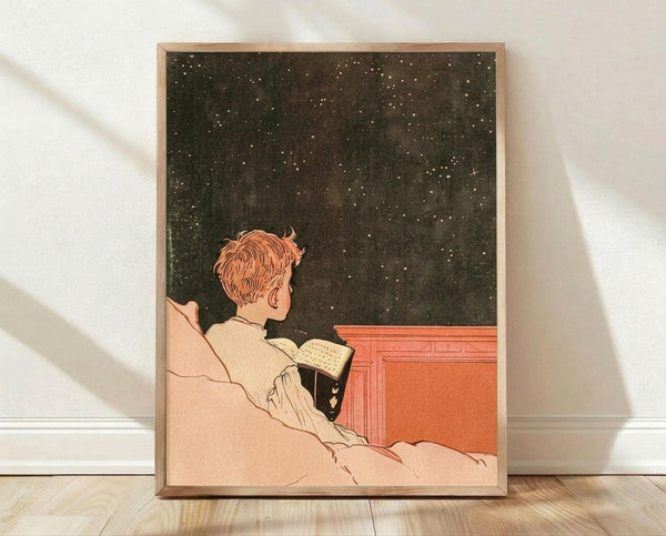 May include: Framed vintage art print showing person with reddish hair in light colored clothing reading a book while reclining against pillows, gazing up at starry night sky through what appears to be an open window or wall. Orange-red architectural element visible on right side. Artwork has muted earth tones with dark star-filled background. Natural wood frame displayed on light wooden floor against white textured wall with soft window light shadows.