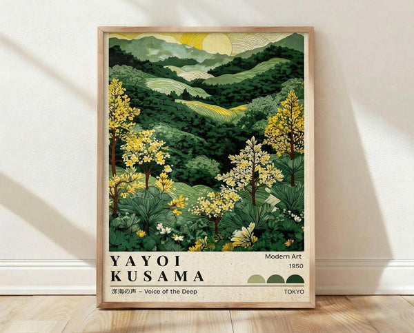May include: A framed art print leaning against a white wall on light wood flooring. The poster features a lush green landscape with rolling hills, yellow flowering trees, and a golden sun with radiating lines in a Japanese woodblock print style. The artwork has rich emerald and forest green tones with bright yellow accents. Below the illustration is cream-colored text reading "YAYOI KUSAMA" with Japanese characters and "Modern Art 1950 TOKYO" along with small green circles. The print is