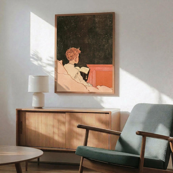 May include: Framed vintage poster showing person with reddish hair in white clothing reading book against starry night sky background in coral and dark green tones. Displayed above wooden sideboard with white ceramic lamp in modern living room with mint green upholstered chair and natural lighting creating geometric shadows on white wall.