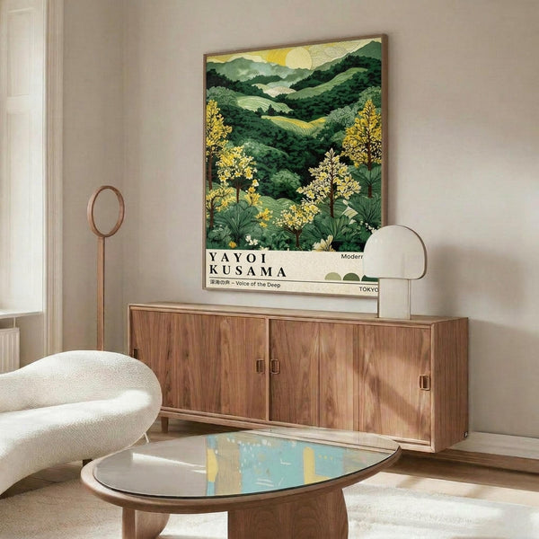 May include: Framed art print featuring rolling green hills, yellow flowering trees, and mountains under a golden sun in Japanese landscape style, displayed above a mid-century walnut credenza with sliding doors. White sculptural chair and oval glass coffee table complete the modern living room setting with cream walls and natural lighting.