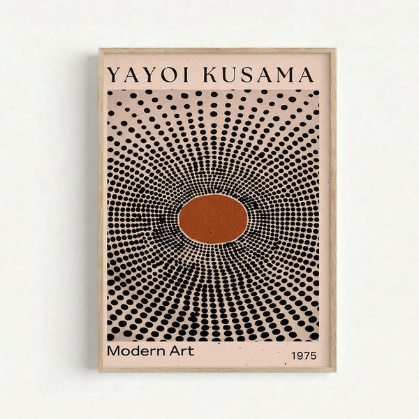 Framed art print featuring a radiating pattern of black polka dots emanating from a central orange oval on a beige background. The dots start small at the center and gradually increase in size toward the edges, creating an optical illusion effect. Text reads "YAYOI KUSAMA" at the top, "Modern Art" and "1975" at the bottom. Displayed in a light wood frame against a white wall.
