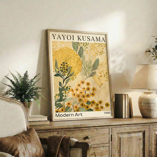 May include: Framed botanical art print with yellow and green floral patterns in Kusama's dotted style, displayed on rustic wood sideboard with decorative pottery, books, and fern plant in neutral-toned living room setting