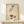 May include: Vintage art print in wooden frame showing an elegant hand dropping jewelry into a terracotta bowl. The illustration features delicate line work on aged cream paper, depicting a feminine hand with ruffled sleeve cuff releasing rings and gems. Displayed on light wood console with small wrapped gift, against neutral wall with soft natural lighting.