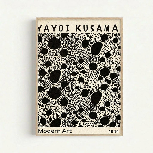 Framed poster with cream background featuring black polka dots in varying sizes creating an infinite pattern. Text reads "YAYOI KUSAMA" at top and "Modern Art 1944" at bottom. The dots range from tiny speckles to large circles, densely packed across the surface. Light wood frame against white wall.