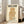 May include: Framed vintage-style poster with cream background featuring geometric owl design in golden brown lines and patterns. Japanese text at top, English text below reading "International Peace Society" and "Tokyo Municipal Museum, Ueno - April 1-19, 1974". Light wood frame leaning against white wall next to beige upholstered chair in bright room with large windows.