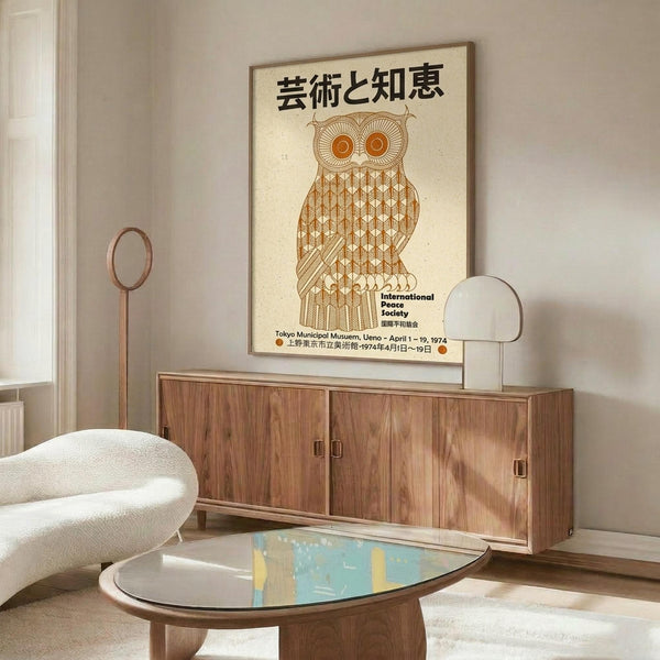 May include: Vintage Japanese owl poster with geometric patterns in warm brown and orange tones, featuring Japanese text and "International Peace Society" branding. The framed artwork is displayed above a mid-century modern walnut credenza with sliding doors. A curved white chair and oval glass coffee table with colorful abstract design complete the minimalist living room scene with white walls and natural lighting.