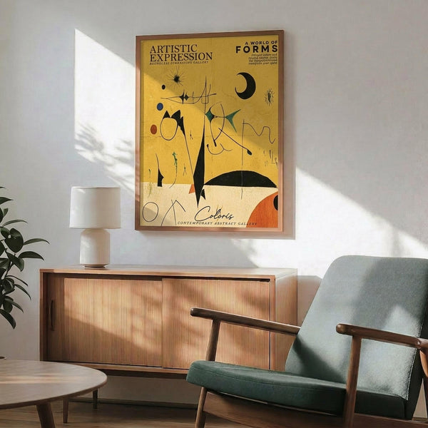 May include: Abstract art poster with yellow and cream background featuring black geometric shapes, colorful dots, and curved lines in Miro's surrealist style. Wooden-framed print hangs above mid-century modern walnut credenza with white ceramic lamp. Sage green upholstered chair with wooden arms sits nearby. Natural sunlight creates shadows on white wall. Indoor plant visible on left side of minimalist living room setting.