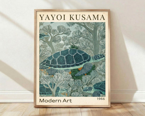 May include: Framed poster print leaning against white wall on light wood floor. Features green sea turtle swimming among coral-like underwater plants in muted blue-green tones. Art styled after Yayoi Kusama with "Modern Art 1966" text. Natural wood frame, soft lighting creates gentle shadows on textured white fabric backdrop.