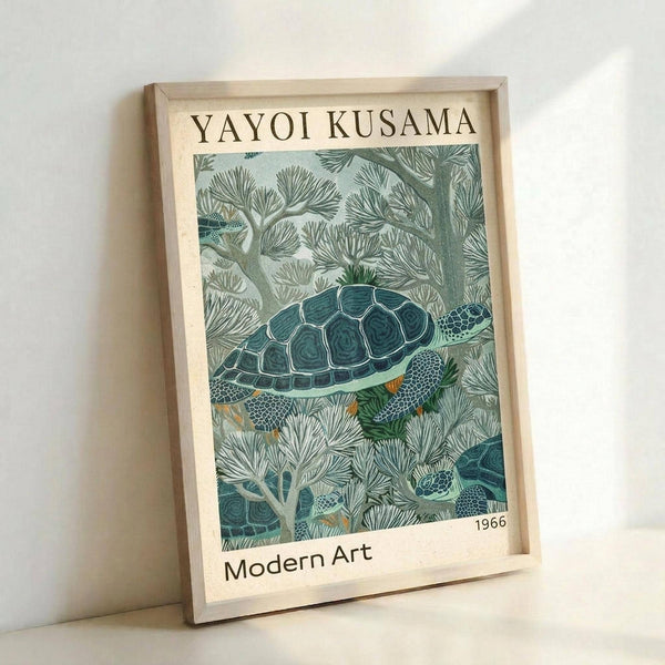 May include: Framed art print leaning against white wall featuring a detailed illustration of a sea turtle swimming among coral and seaweed in muted green and teal tones. The poster has "YAYOI KUSAMA" at top, "Modern Art" and "1966" at bottom on cream background. Natural wood frame, photographed at an angle showing depth and shadow.