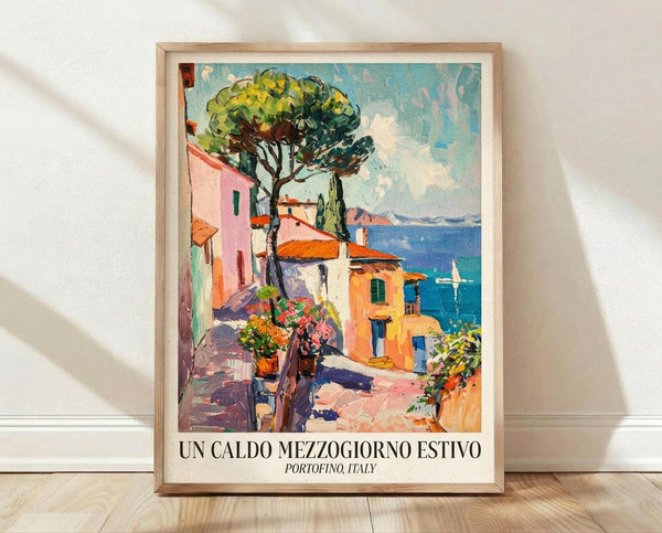 May include: Framed travel poster print featuring a vibrant Mediterranean coastal scene with colorful buildings in pink, orange and yellow, large green tree, stone steps, flowering plants in pots, and blue ocean with sailboat. Painted in impressionistic style with bold brushstrokes. Light wood frame with white matting, leaning against white wall on wooden floor with natural lighting casting shadows.