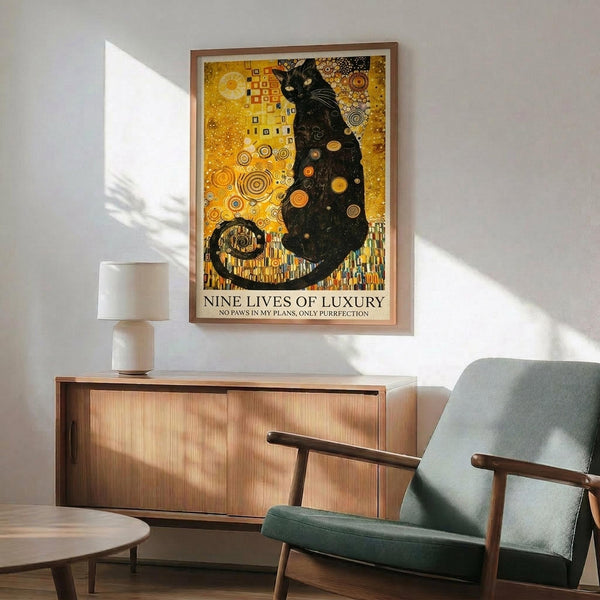 May include: Framed art print featuring a black cat in Gustav Klimt's golden decorative style with ornate circles and patterns on a golden yellow background, displayed above a wooden sideboard with white ceramic lamp in a modern living room setting with teal upholstered chair and natural lighting creating geometric shadows on white wall.