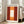 May include: Framed poster print in light wood frame leaning against white wall next to beige sofa. Abstract artwork features deep red background with central vertical rectangle in white and orange tones with soft, blurred edges. Text reads "MARK ROTHKO" at top and "Modern Art" at bottom. Natural lighting creates shadows on hardwood floor in bright, minimalist living room setting.