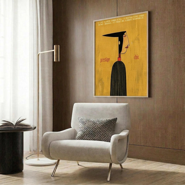 May include: Yellow vintage-style French poster with stylized woman's profile in black hair and striped dress, displaying "prestige" and "chic" text. Shown framed on wood-paneled wall above beige upholstered armchair with geometric pillow, beside brass floor lamp and dark round side table with open book.