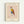 Framed poster featuring a geometric owl illustration in Picasso's minimalist style, with angular shapes in red, yellow, blue, and brown colors. The owl has large circular eyes and thin line-drawn legs. The artwork is displayed in a light wood frame with cream matting against a white wall. Text reads "PICASSO" at top, "The Met" and "L'Art Minimaliste" at bottom, with Picasso's signature visible on the artwork.