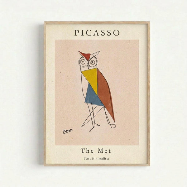 Framed poster featuring a geometric owl illustration in Picasso's minimalist style, with angular shapes in red, yellow, blue, and brown colors. The owl has large circular eyes and thin line-drawn legs. The artwork is displayed in a light wood frame with cream matting against a white wall. Text reads "PICASSO" at top, "The Met" and "L'Art Minimaliste" at bottom, with Picasso's signature visible on the artwork.