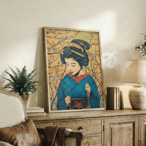May include: Framed Japanese-style artwork showing a geisha in blue kimono with elaborate dark hair ornament, set against golden background with cherry blossoms, displayed on rustic wooden sideboard alongside books, ceramic vase, and fern plant in modern living room with beige chair and neutral walls.