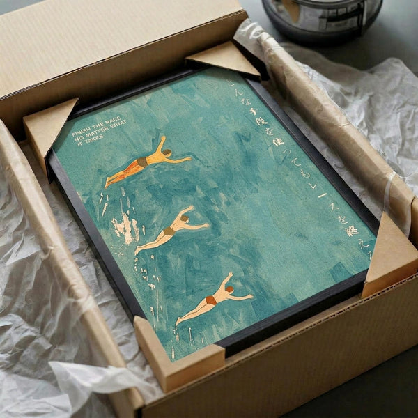 May include: Framed vintage-style turquoise poster with three orange silhouettes of swimmers diving and swimming underwater, Japanese text along the right side, and English quote "Finish the race, no matter what it takes" in upper left corner. The black-framed artwork is nestled in brown cardboard packaging with white tissue paper, surrounded by shipping materials on a neutral surface.