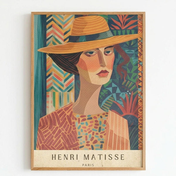 A stylized portrait of a woman wearing an orange wide-brimmed hat with dark ribbon, rendered in vibrant geometric patterns and bold colors including oranges, teals, and earth tones. The artwork features decorative tropical and abstract motifs in the background with chevron and leaf patterns. The piece is displayed in a light wood frame against a white wall, with "HENRI MATISSE PARIS" text at the bottom in a vintage exhibition poster style.
