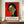 May include: Framed art print featuring a cubist-style portrait of a woman with black hair and red lips against a vibrant red background, displayed on a wooden sideboard next to a white ceramic vase and stacked books in a modern interior with white paneled walls