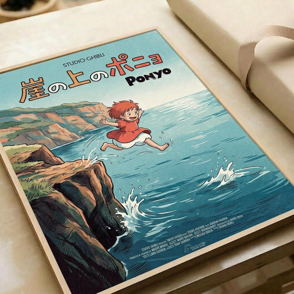 A vintage-style poster featuring Ponyo, a red-haired character in an orange dress, leaping joyfully over ocean waves near rocky coastal cliffs. The artwork displays soft blues and turquoise water with white foam splashes, brown and tan cliff formations, and Japanese text at the top reading "Studio Ghibli" and "Ponyo" in red lettering. The poster lies flat on a white surface next to rolled white paper, showing the classic anime illustration style with detailed water movement and coastal s