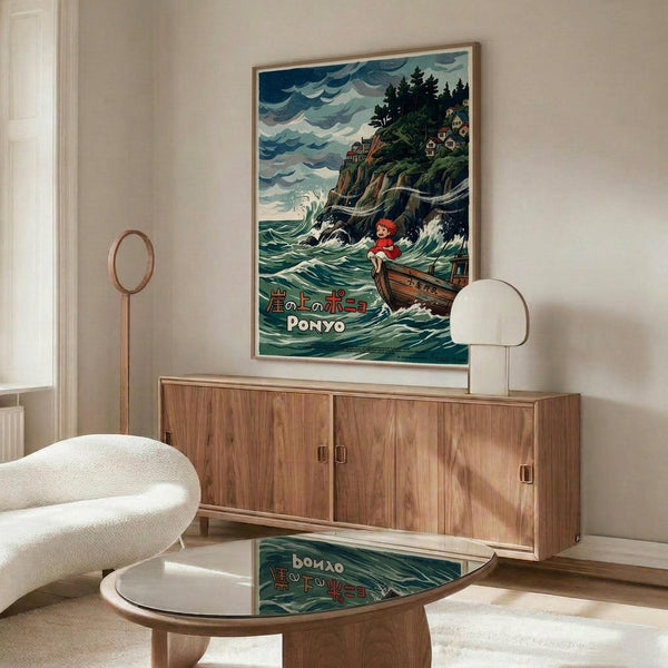 May include: Framed Studio Ghibli Ponyo poster displayed above a mid-century modern walnut credenza in a minimalist living room. The colorful artwork shows a red-haired character in a wooden boat on stormy ocean waves near a cliff with houses. White sculptural chair and round glass coffee table complete the Scandinavian-style interior with cream walls and natural lighting.