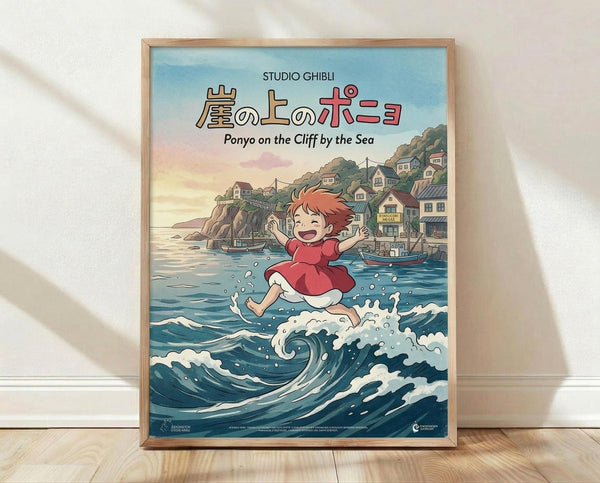 May include: Framed Studio Ghibli Ponyo movie poster featuring red-haired girl in red dress jumping over ocean waves with coastal village on cliffs in background. Wooden frame displayed against white wall on light wood floor with natural lighting creating soft shadows.