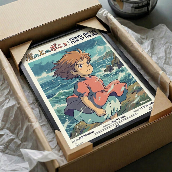 May include: Framed anime poster of young girl with brown hair in coral red dress sitting by turbulent ocean waves, featuring Japanese text at top. Poster shown in black frame inside cardboard shipping box with white tissue paper padding on white surface.