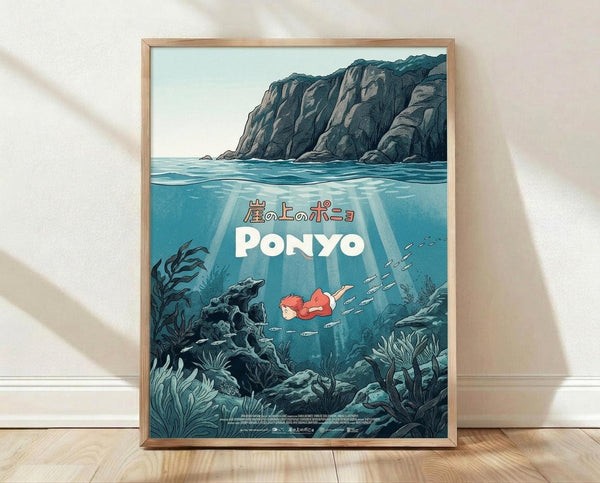 May include: Framed poster print in light wood frame leaning against white textured wall on wooden floor. Artwork shows underwater scene with red-haired character swimming among fish, surrounded by seaweed and coral formations. Above water shows dramatic rocky cliffs. Japanese text and "PONYO" in white letters overlay the blue-green aquatic scene. Soft natural lighting creates gentle shadows on wall.
