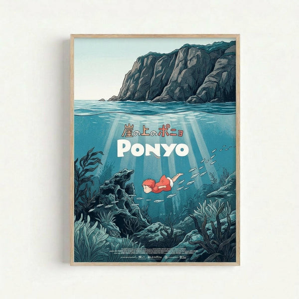 May include: Framed movie poster artwork displayed on white wall featuring underwater scene with small red-haired character swimming among fish, rocky coastal cliffs above water surface, Japanese and English text, all rendered in Studio Ghibli's distinctive animated art style with blues, greens, and coral tones in natural wood frame