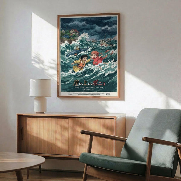 May include: Framed Studio Ghibli Ponyo movie poster mounted on white wall above wooden sideboard with ceramic lamp. Poster shows two children swimming in stormy ocean waves with traditional Japanese text below. Mid-century modern room setting with sage green armchair, round coffee table, and natural lighting casting shadows across the scene.