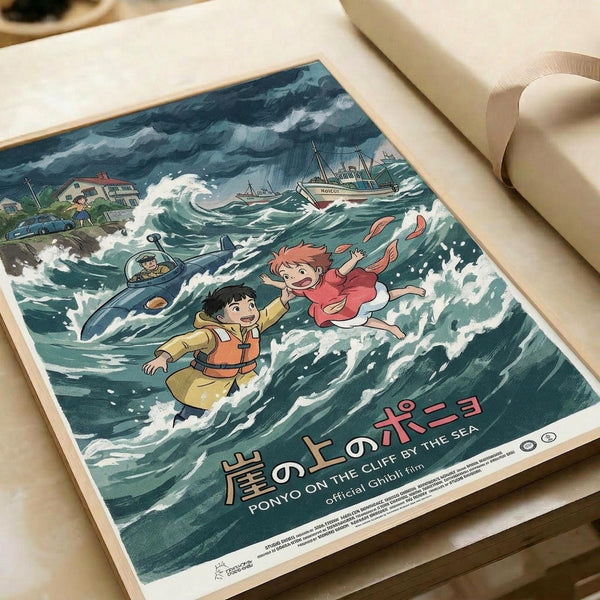 May include: Studio Ghibli Ponyo poster print displayed on white paper with cream ribbon nearby. The colorful anime artwork shows characters in turbulent ocean waves with boats and houses in background. Japanese and English text at bottom reads "Ponyo on the Cliff by the Sea." Vintage-style illustration features blue-green stormy seas, red-haired girl character, and boy in yellow jacket amid dramatic white-capped waves.