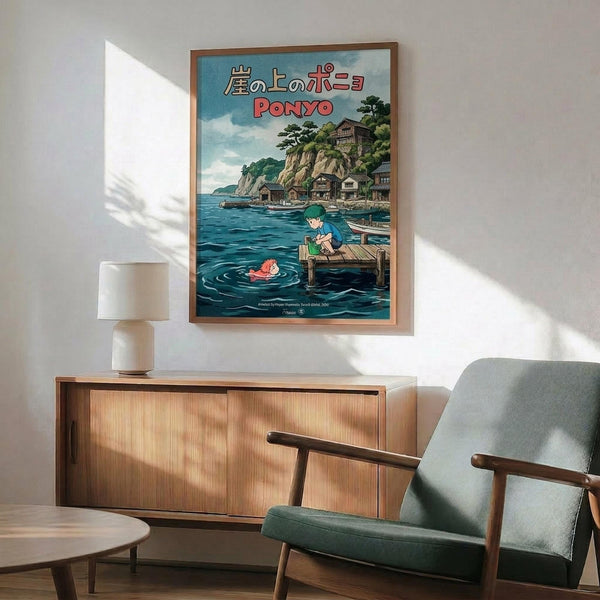 May include: Framed Ponyo poster on white wall above wooden credenza with lamp and mid-century modern teal armchair. Poster shows animated scene with boy on wooden dock, red-haired girl swimming in blue water, and coastal village with traditional houses on clifftop. Japanese text and "PONYO" title visible. Warm natural lighting creates geometric shadows across minimalist room setting.