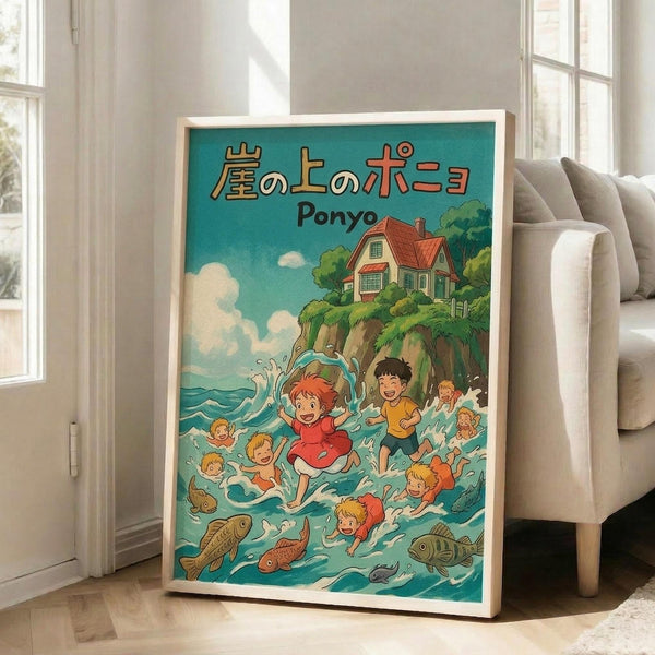 May include: A framed poster featuring Studio Ghibli's Ponyo in vibrant anime style, showing children swimming in turquoise ocean water with colorful fish, a clifftop house with red roof surrounded by green trees against blue sky with white clouds, Japanese text at top, displayed in bright living room setting with beige sofa and large windows.