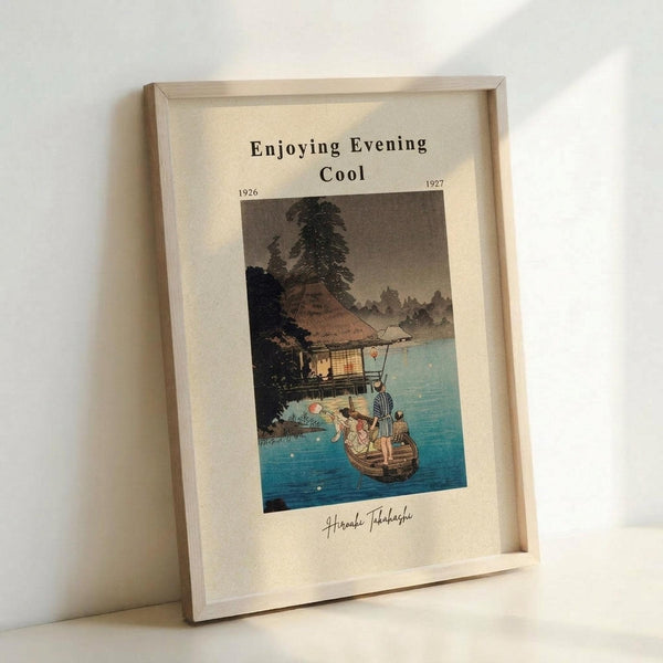 May include: Framed vintage Japanese woodblock print showing people in a small boat on blue water at twilight, with a traditional house and trees on the shoreline. The artwork features muted colors with glowing lantern light, displayed in a light wood frame against a white wall. Print includes "Enjoying Evening Cool" text and dates from 1926-1927, with artist signature at bottom.