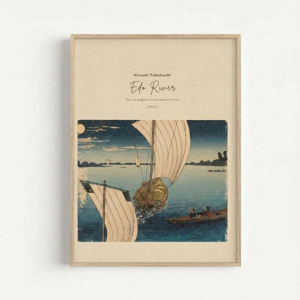 May include: Framed vintage Japanese woodblock print showing sailing boats on blue water under evening sky with full moon. Art features traditional ukiyo-e style with muted blues, beiges and earth tones. Print displayed in light wood frame against cream textured background on white wall, creating soft shadow.