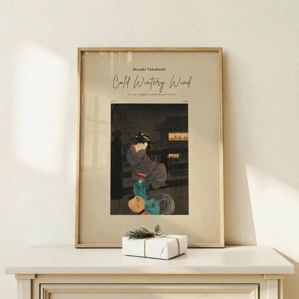 May include: Framed vintage Japanese woodblock print poster displayed on light wood shelf against cream wall. Features woman in dark kimono with teal accents sitting by wooden structure. Museum exhibition poster style with beige matting in natural wood frame. Small white wrapped gift with greenery sits beside frame.