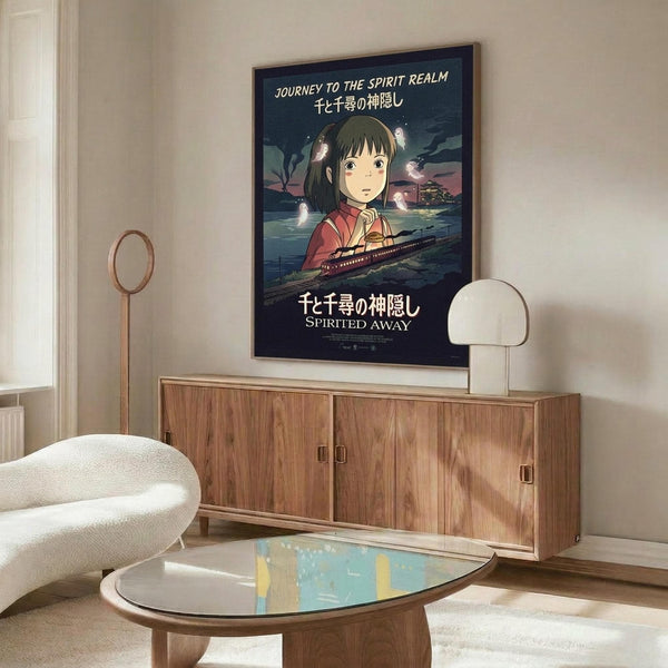 May include: Framed Spirited Away movie poster mounted on wall above wooden sideboard in modern living room. Poster features anime girl character Chihiro in red outfit with train and floating spirits on dark background. White upholstered chair, glass coffee table, and table lamp visible in minimalist interior setting with neutral beige walls.