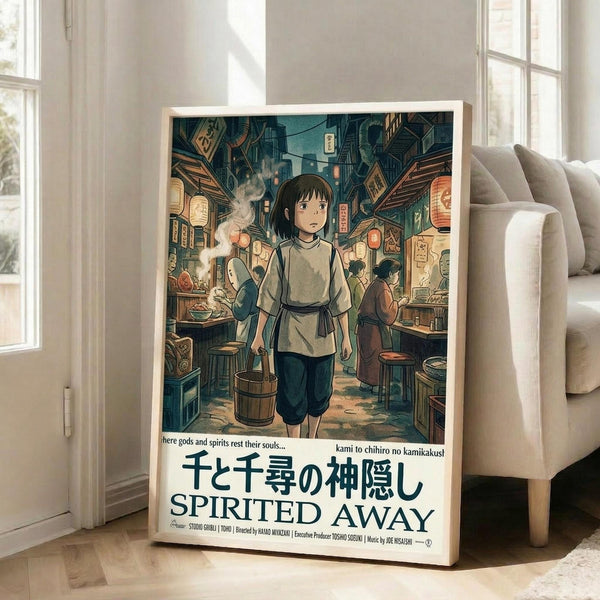 May include: Framed movie poster leaning against white wall next to beige sofa in bright living room with windows. Poster shows anime-style girl in traditional Japanese clothing carrying wooden bucket through bustling marketplace with lanterns and food stalls. Rich teal and orange colors throughout detailed street scene. Japanese and English text at bottom reads "Spirited Away" with Studio Ghibli credits.