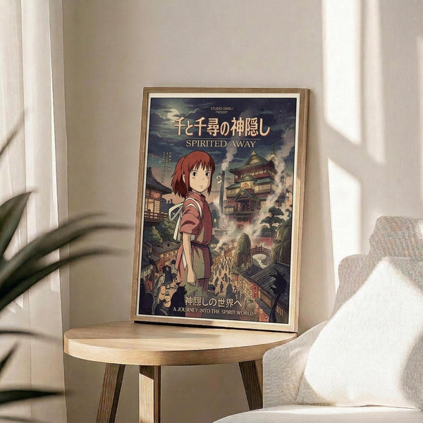 May include: Framed Spirited Away movie poster featuring Chihiro in pink dress against mystical Japanese bathhouse backdrop, displayed on wooden round side table next to beige upholstered chair with decorative plant nearby. Natural sunlight casts shadows across neutral-toned room setting. Poster shows detailed anime artwork with Japanese text and "Studio Ghibli Presents" branding in traditional illustration style.