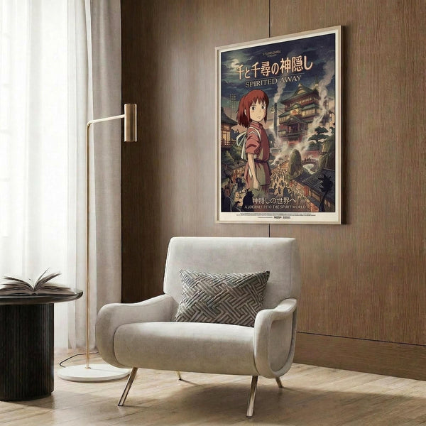 May include: Framed Spirited Away movie poster mounted on wood-paneled wall above beige upholstered armchair with geometric patterned pillow. Poster features anime character with reddish-brown hair in traditional clothing against fantastical Japanese architecture background with Japanese and English text. Modern reading nook setting with golden floor lamp and dark side table with open book.
