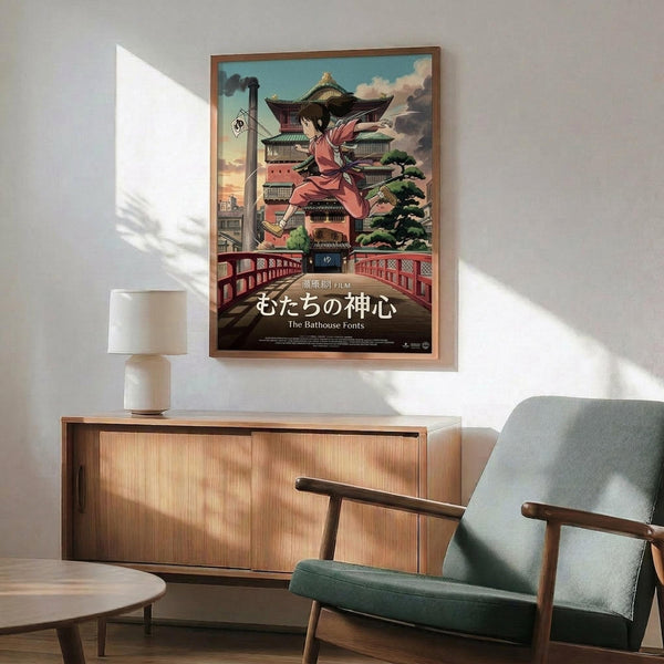 May include: Framed anime poster showing young girl in pink kimono leaping in front of ornate multi-story Japanese bathhouse with traditional curved roofs and red bridge. Poster features Japanese text at bottom. Displayed above mid-century modern wooden sideboard with white ceramic lamp in minimalist room setting with sage green upholstered chair and natural lighting casting geometric shadows on white wall.
